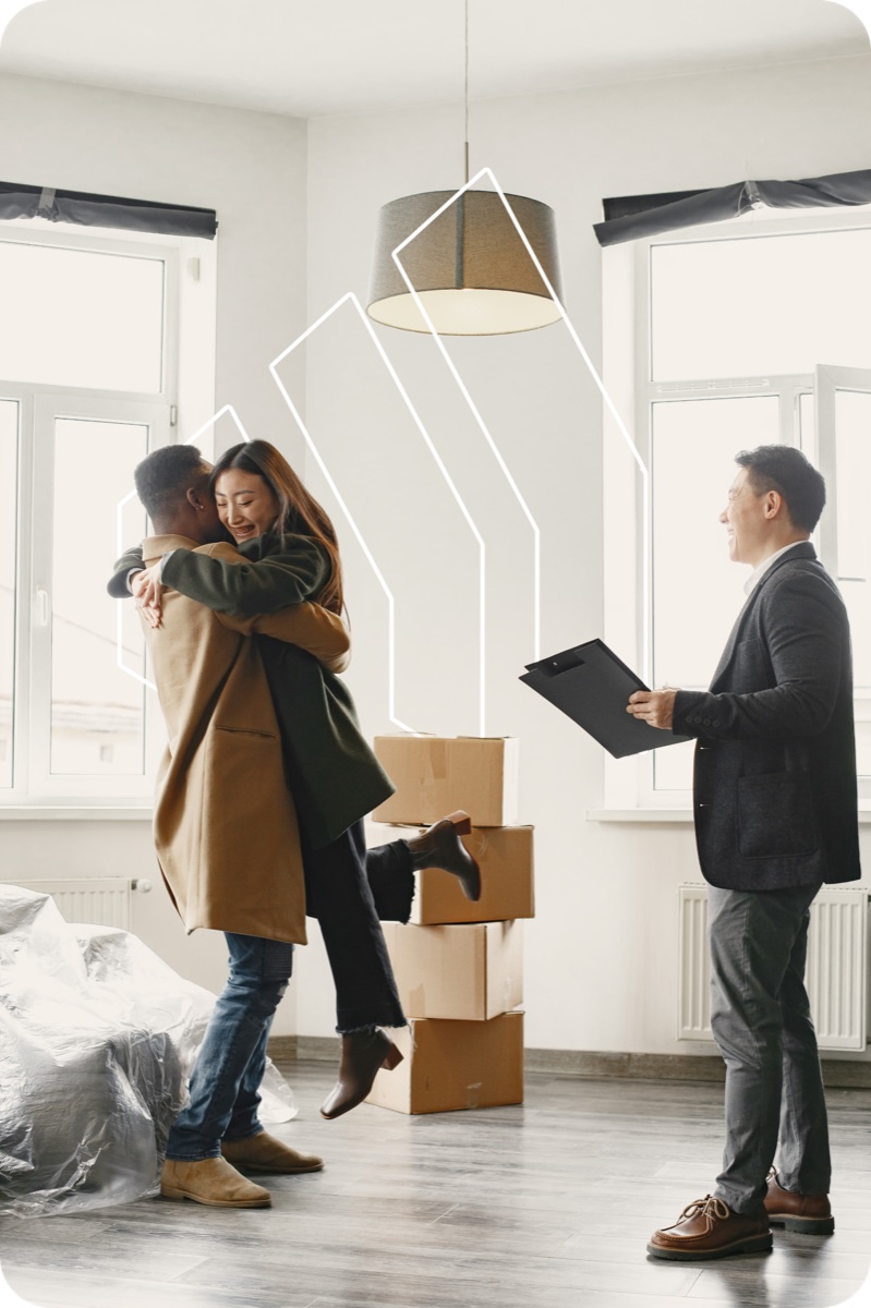 A buyer shaking hands with their agent in an empty living room